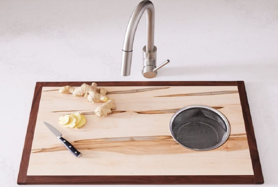 ginger on cutting board with strainer over sink
