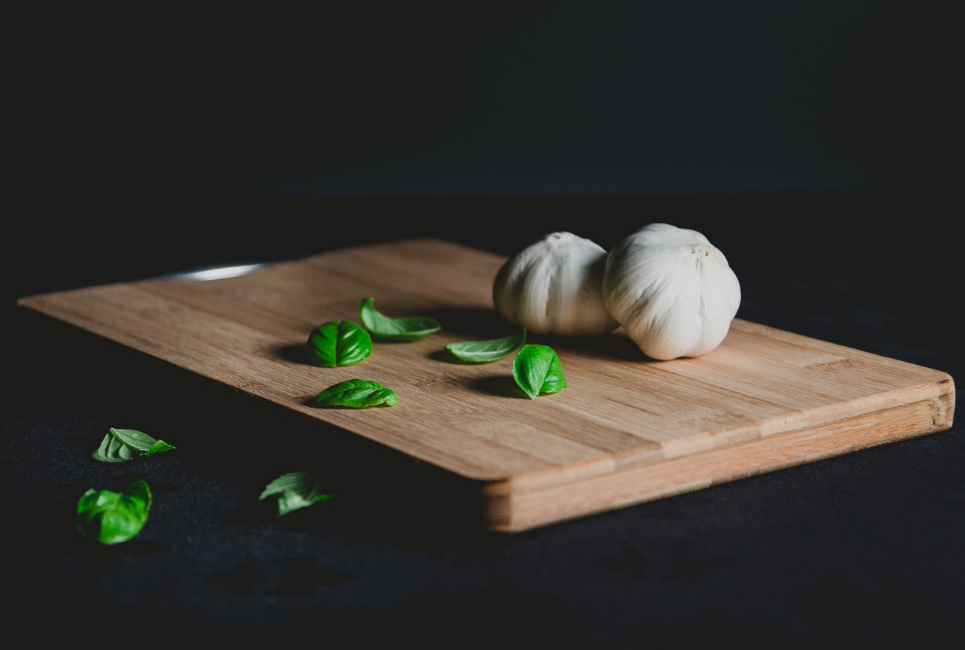 garlic and basil on cutting board
