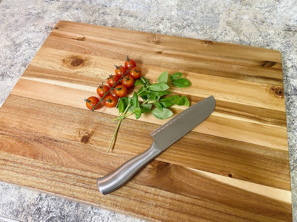 cutting board on tomato greens and knife
