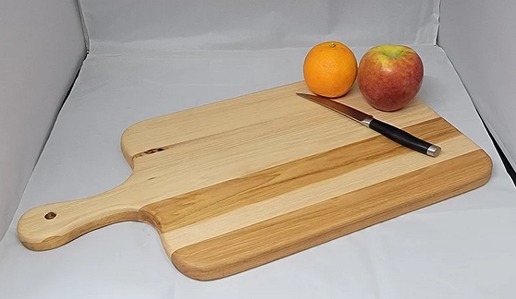 lksd hickory cutting board with fruit and knife beside it