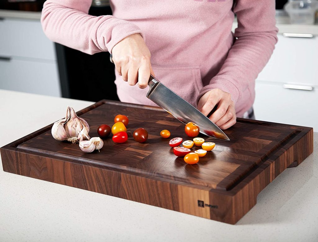 mevell cutting board with woman cutting vegetables