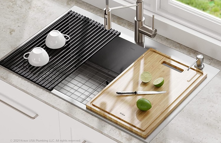 cutting board above sink with lime and knife above it