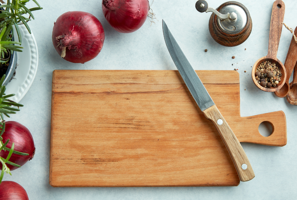 cutting board with red onions and knife