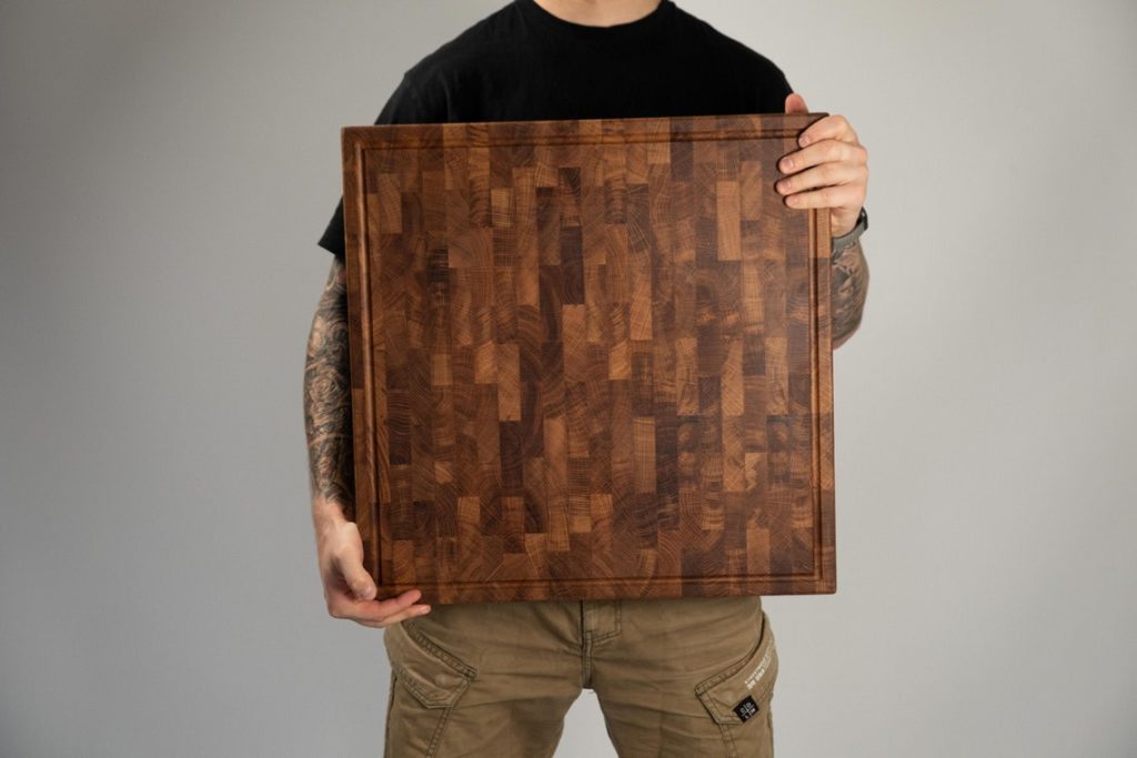 large cutting board being held by man