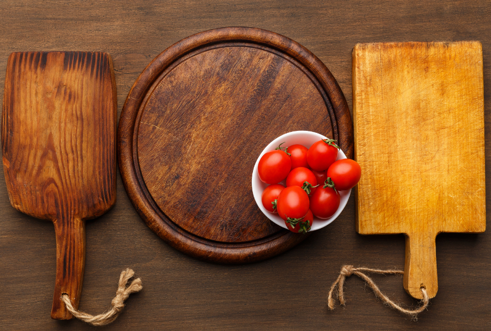 cutting boards on a table with cherry tomatoes