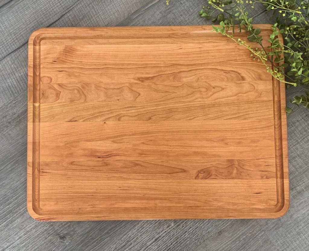 oak cutting board with parsley on side