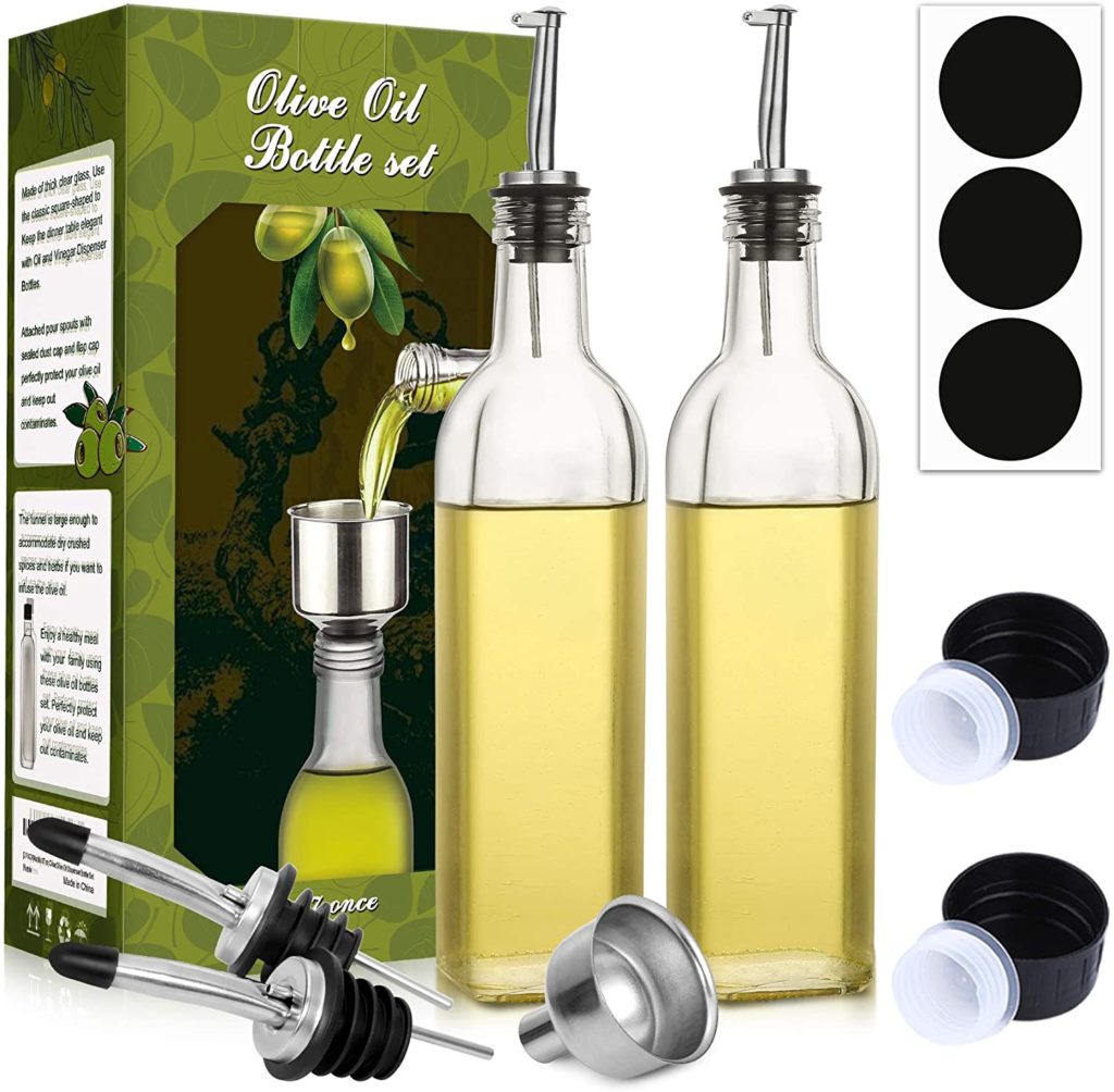 two clear glass olive oil dispensers with spouts and original box