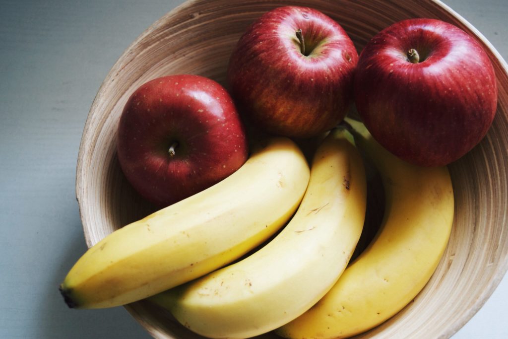 bananas and apples in wooden fruit bowl