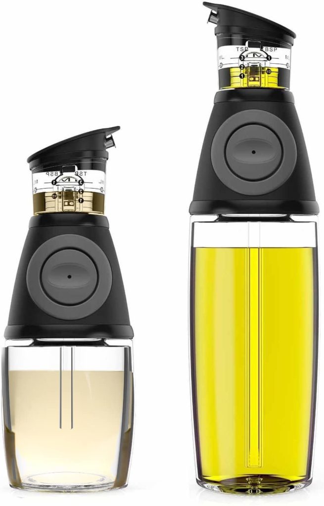 two clear oil dispensers with black pumps