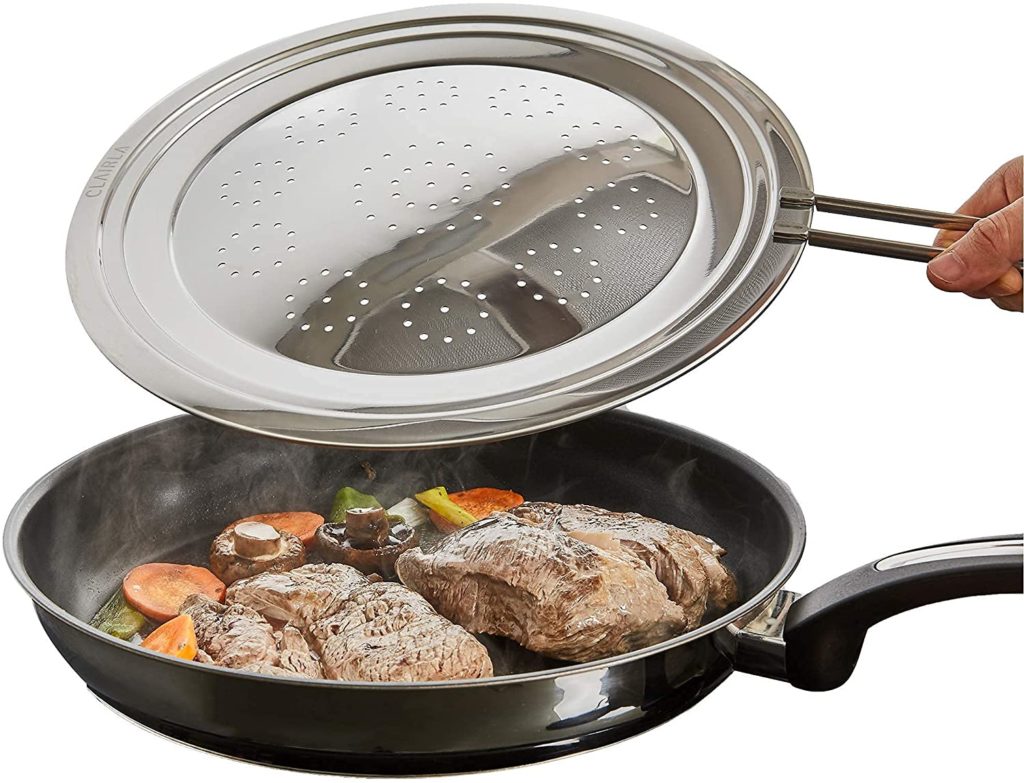 persons hand placing stainless steel grease splatter screen over pan cooking steak