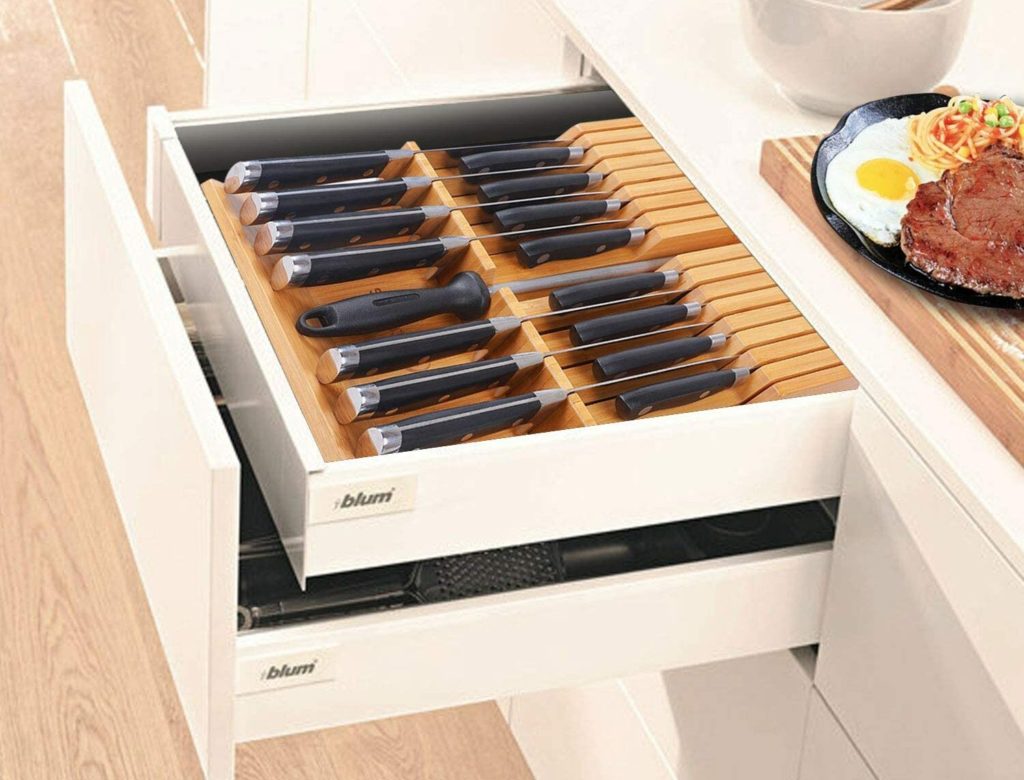 open kitchen drawers with knives stored in bamboo knife holder
