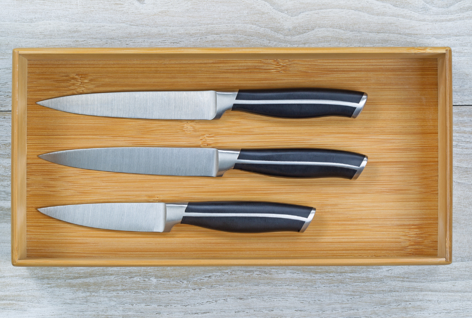three chefs knives in wooden drawer insert