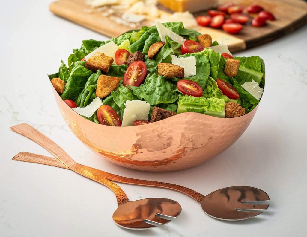 salad in hammerec copper bowl with matching serving utensils