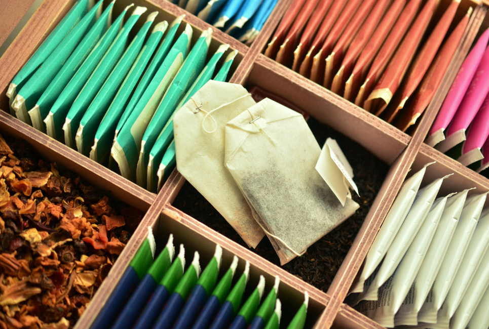 assorted tea bags in wooden organized slots