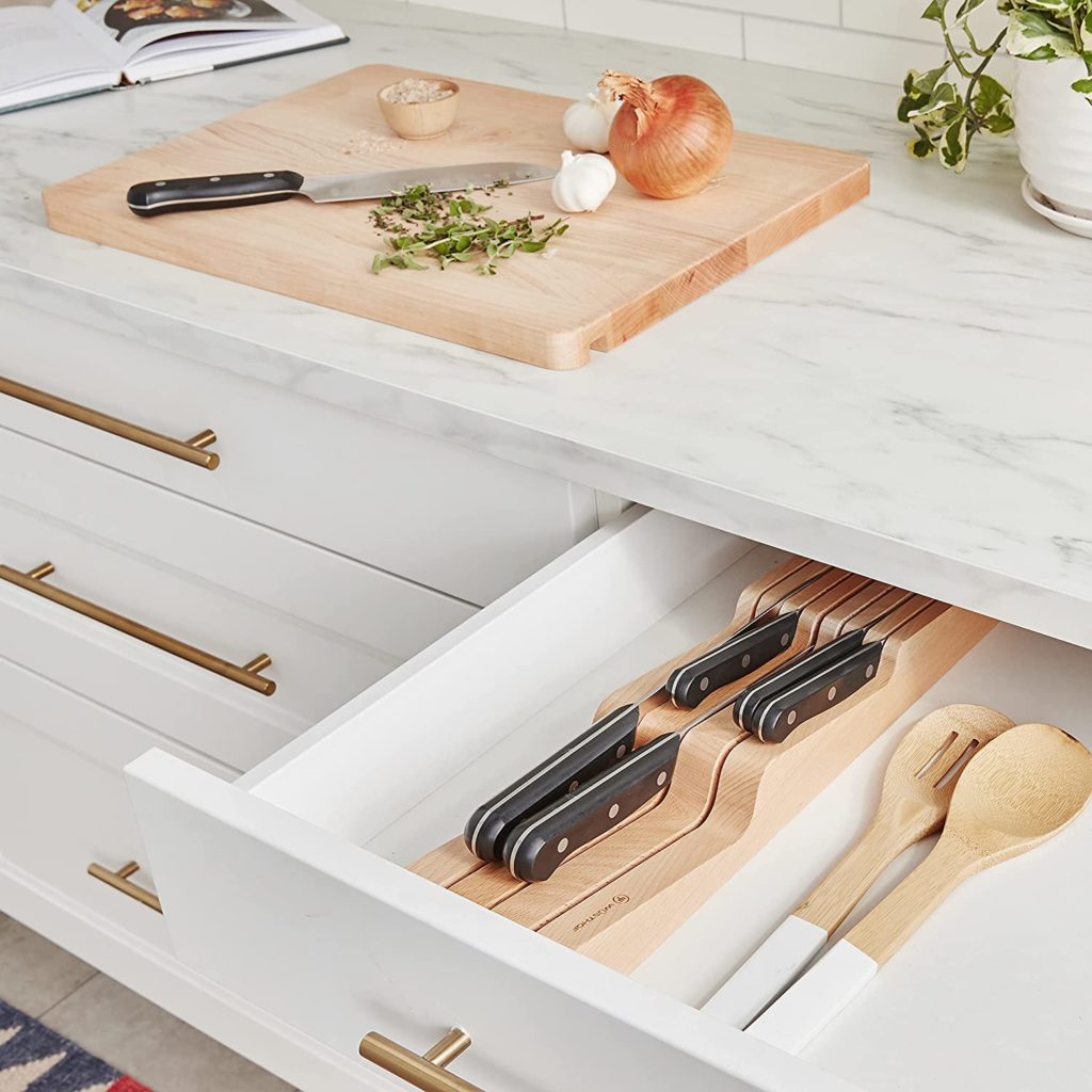 open knife drawer next to cutting board on counter