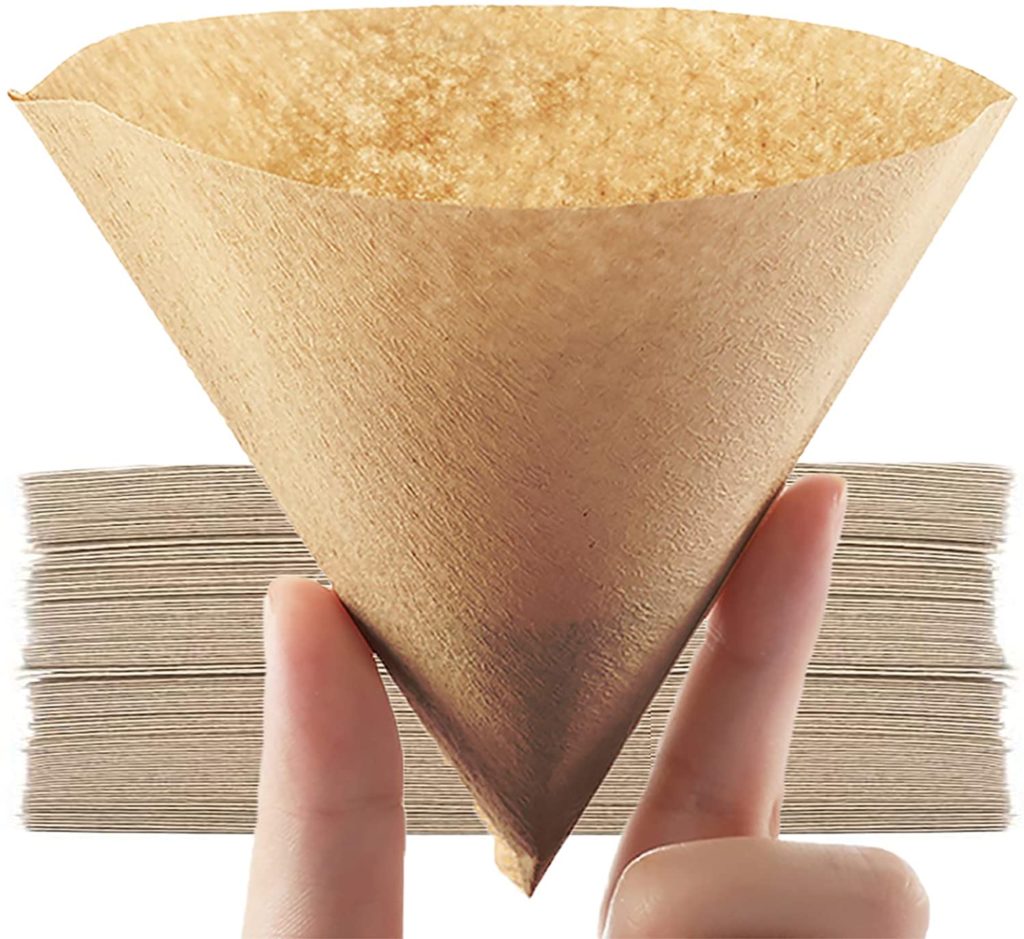 persons fingers hold natural paper coffee filter cone