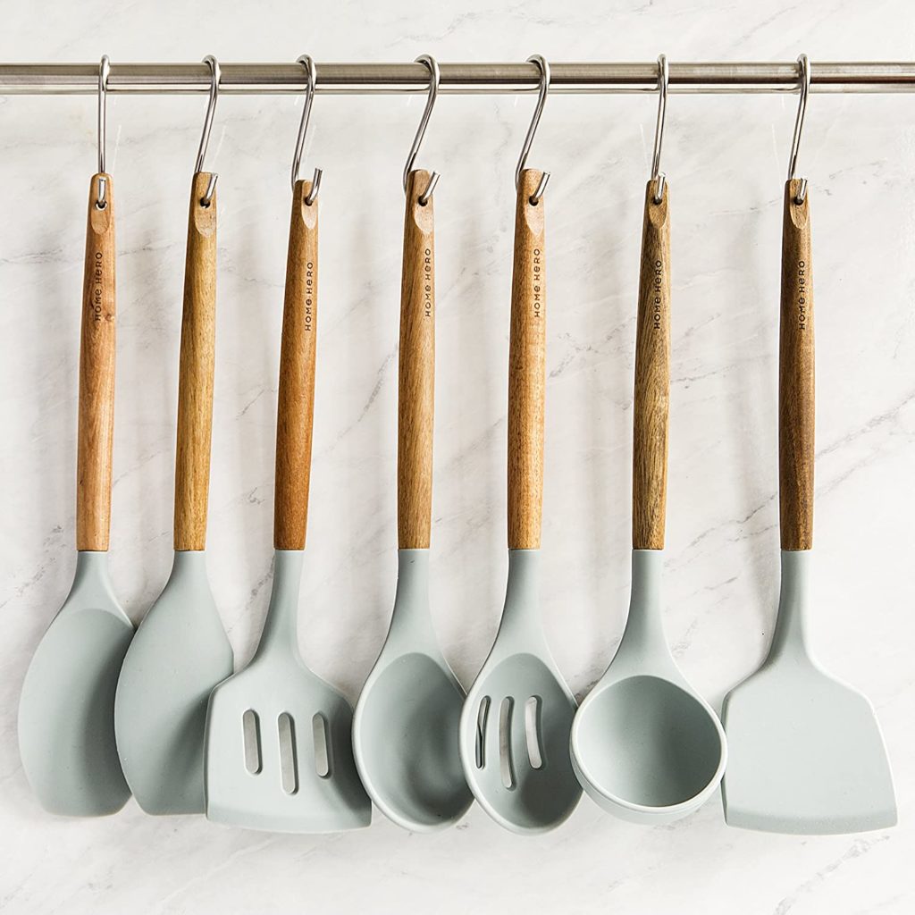 wooden and silicone cooking utensils hanging from hooks