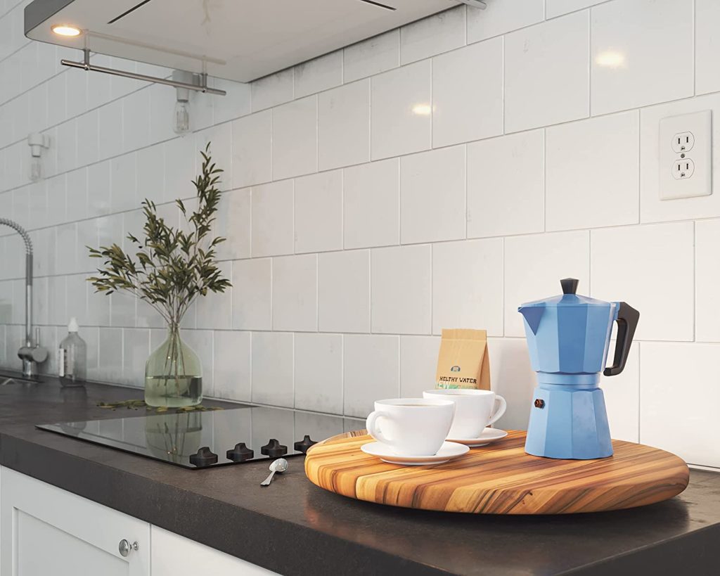 kitchen counterop with lazy susan holding espresso pot and mugs