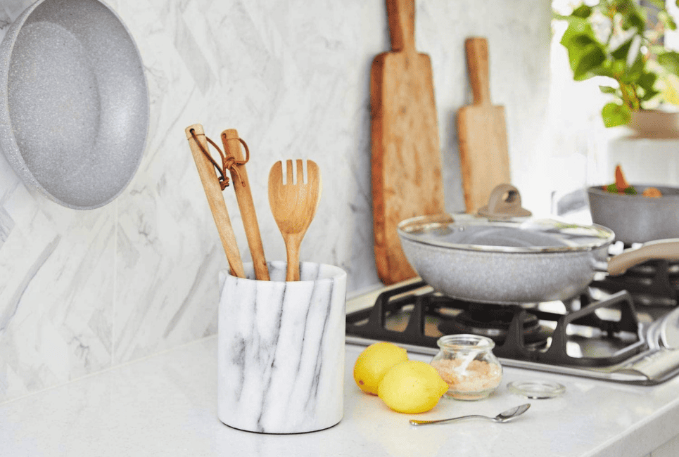 marble utensil holder in modern white kitchen