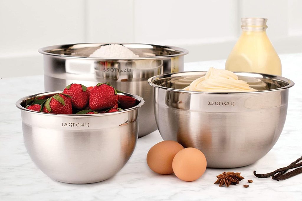 stainless steel mixing bowls on counter with baking ingredients