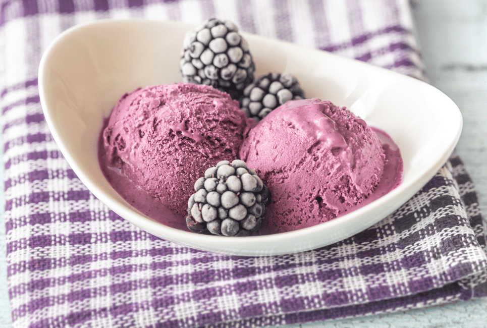 purple ice cream and blackberries in bowl