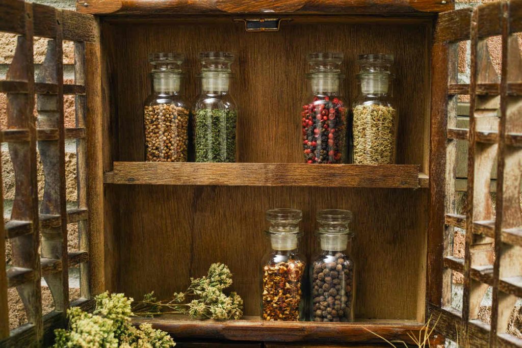 rustic open cabinet with spice jars