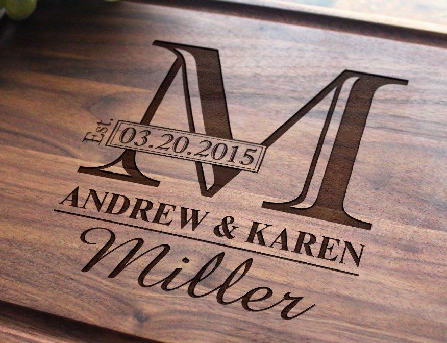 Customized monogrammed burn stamp in wood reading Andrew & Karen Miller