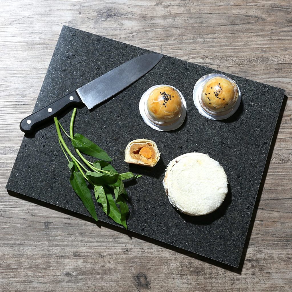 aesthetically pleasing food and knife on granite cutting board