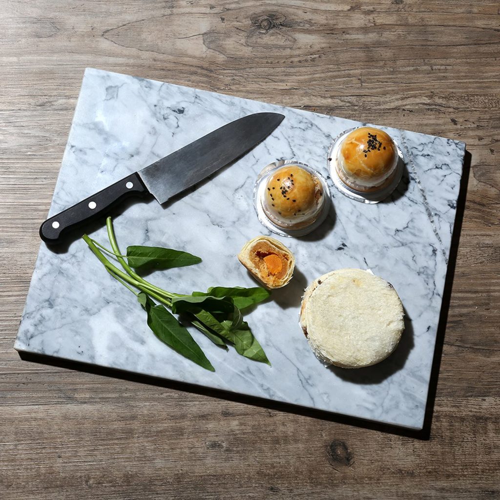 aesthetically pleasing food and knife on marble cutting board
