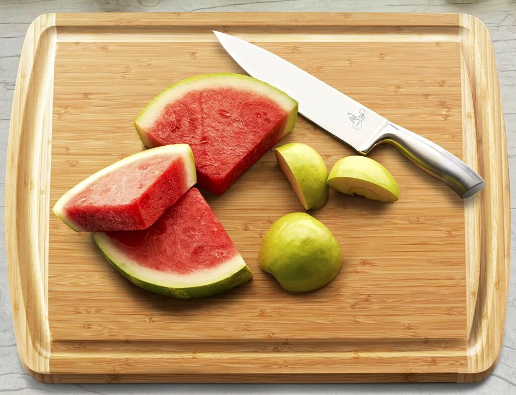 apple and watermelon sliced on wooden cutting board