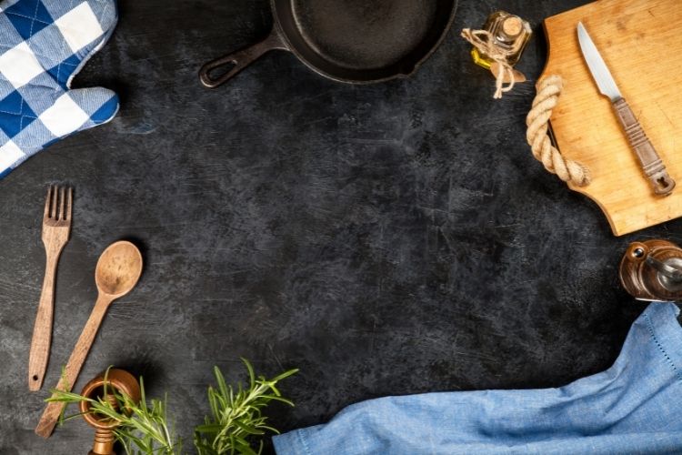 black countertop with cutting board and kitchen accessories