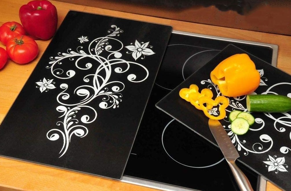 black cutting boards being used with white floral pattern