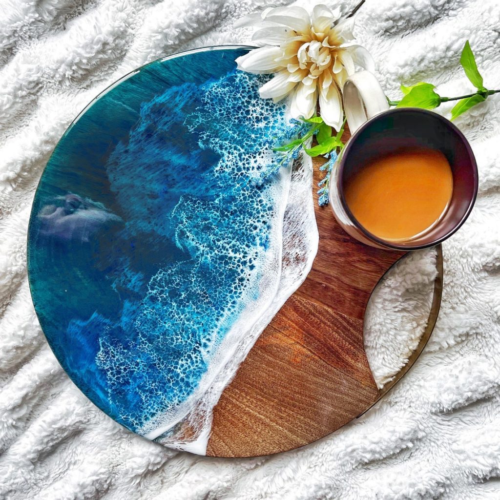 blue and white resin on round wooden cutting board