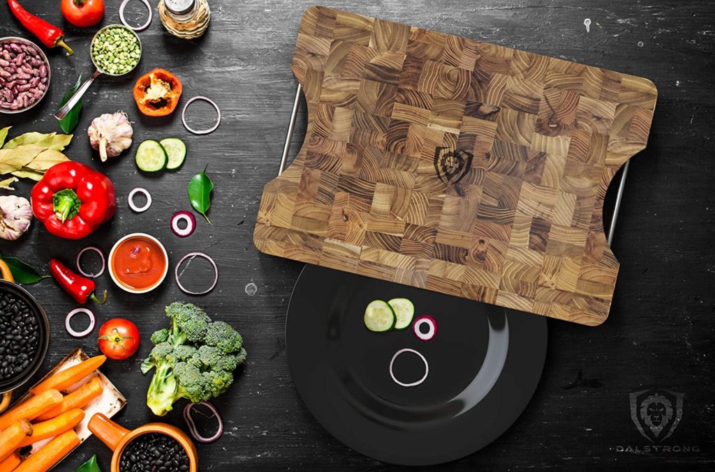 burl cutting board surrounded by produce