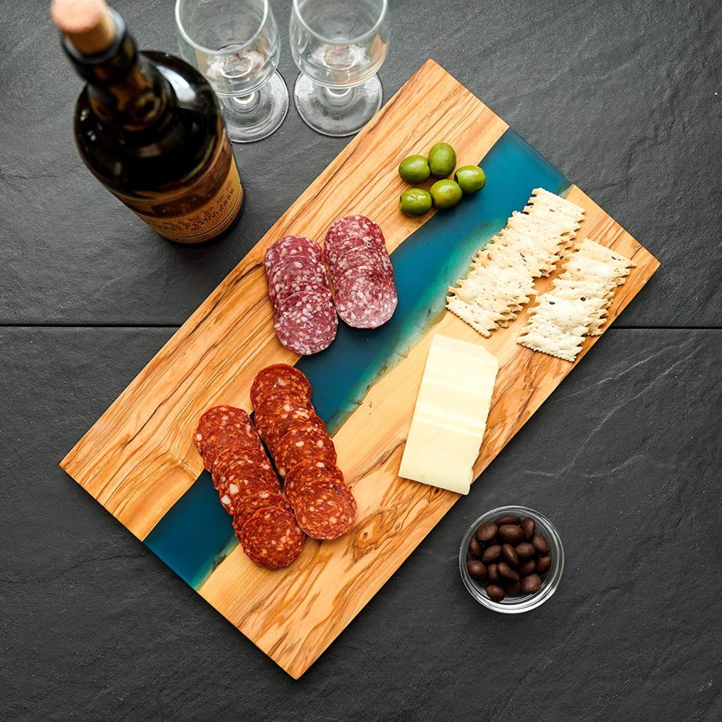 charcuterie board on wooden cutting board with blue and white resin