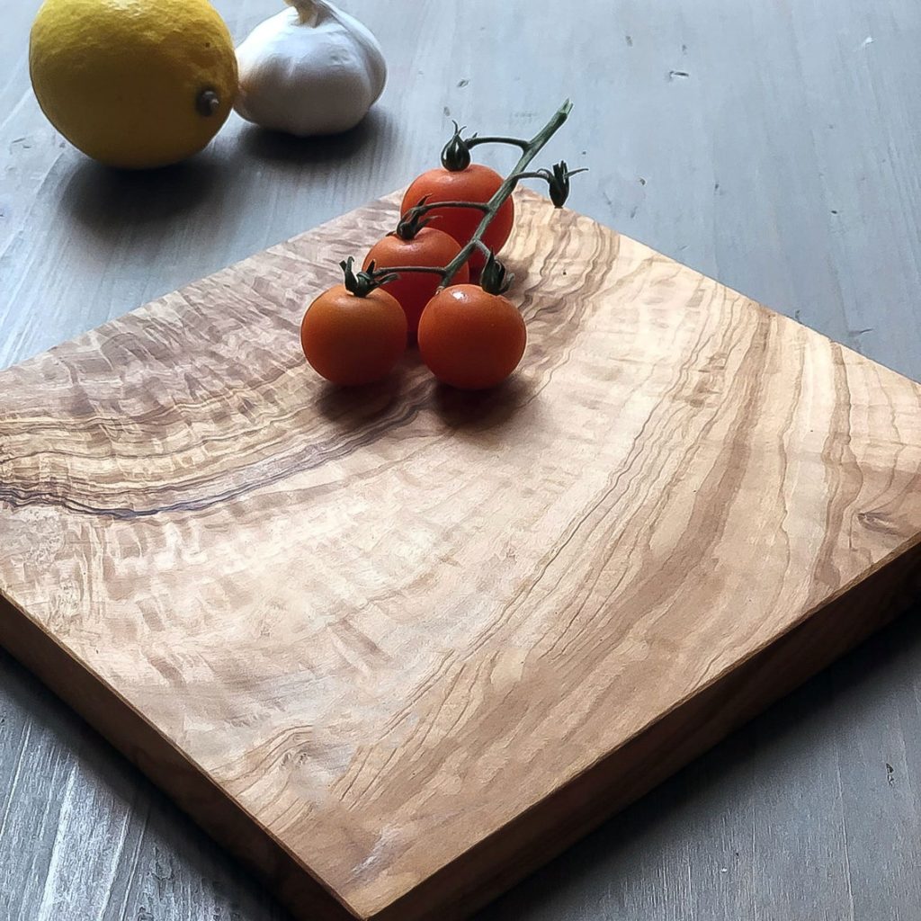 cherry tomatoes on olive wood small square cutting board