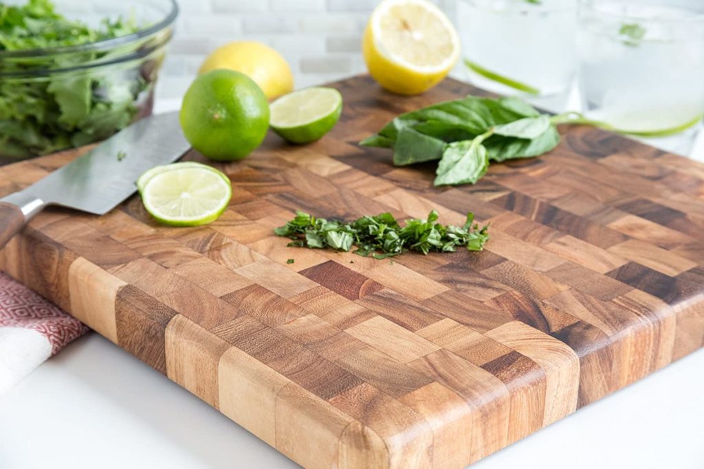 citrus and herbs on thick end grain wooden cutting board