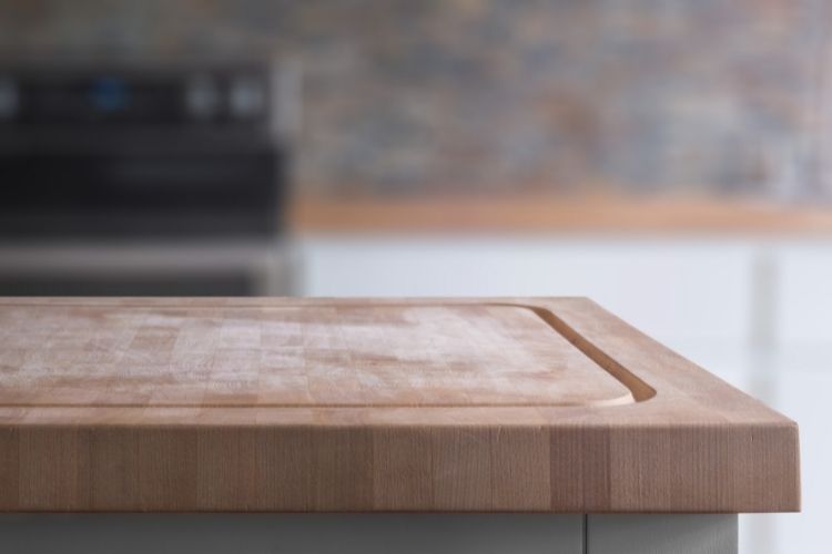close up edge of butcher block cutting board with juice groove