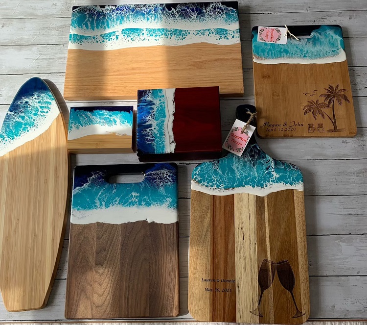 collection of wooden cutting boards with blue and white resin details