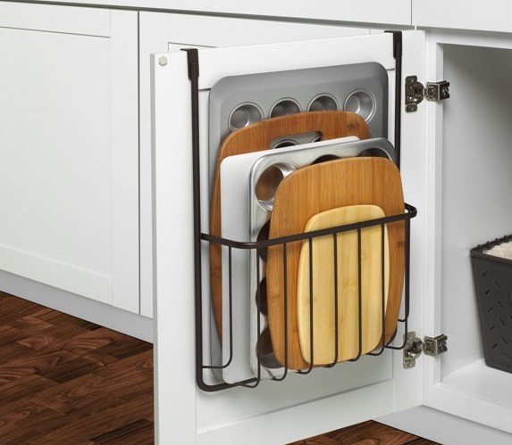 cutting boards and baking tins in over cabinet storage rack