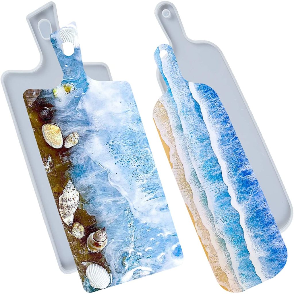 epoxy cutting board designed to look like beach shoreline with seashells
