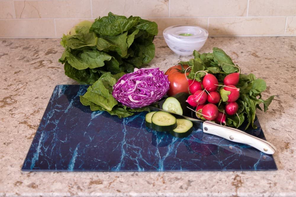 fresh produce on navy blue aquatic design glass cutting board