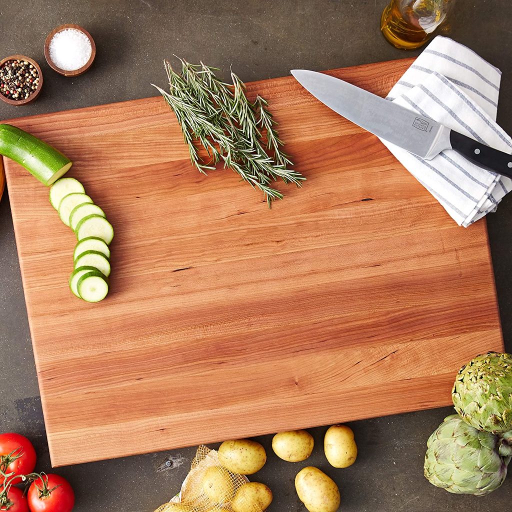 herbs and produce on butcher block cutting board