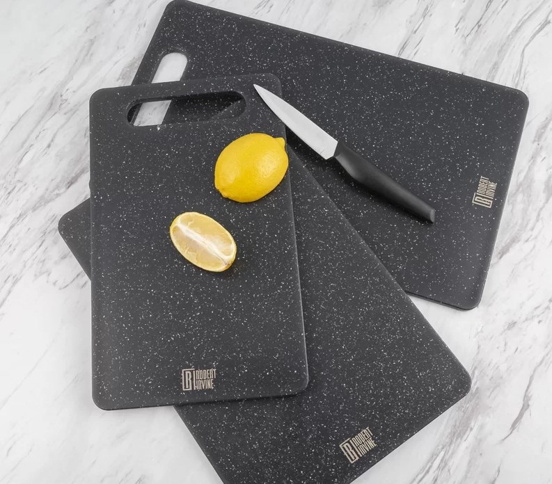 lemon and knife on pack of three black cutting boards