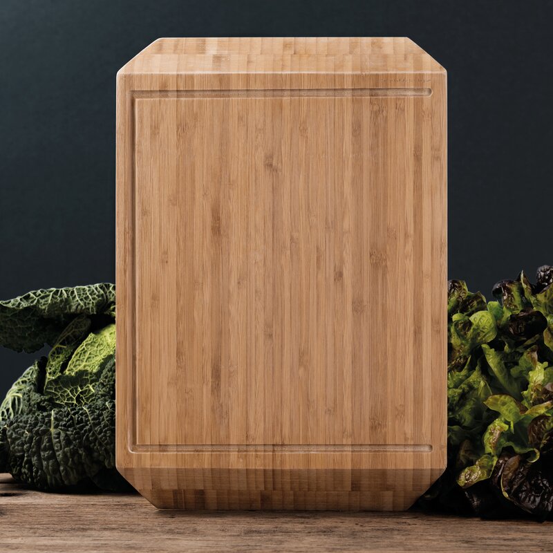 medium colored wooden cutting board with juice groove