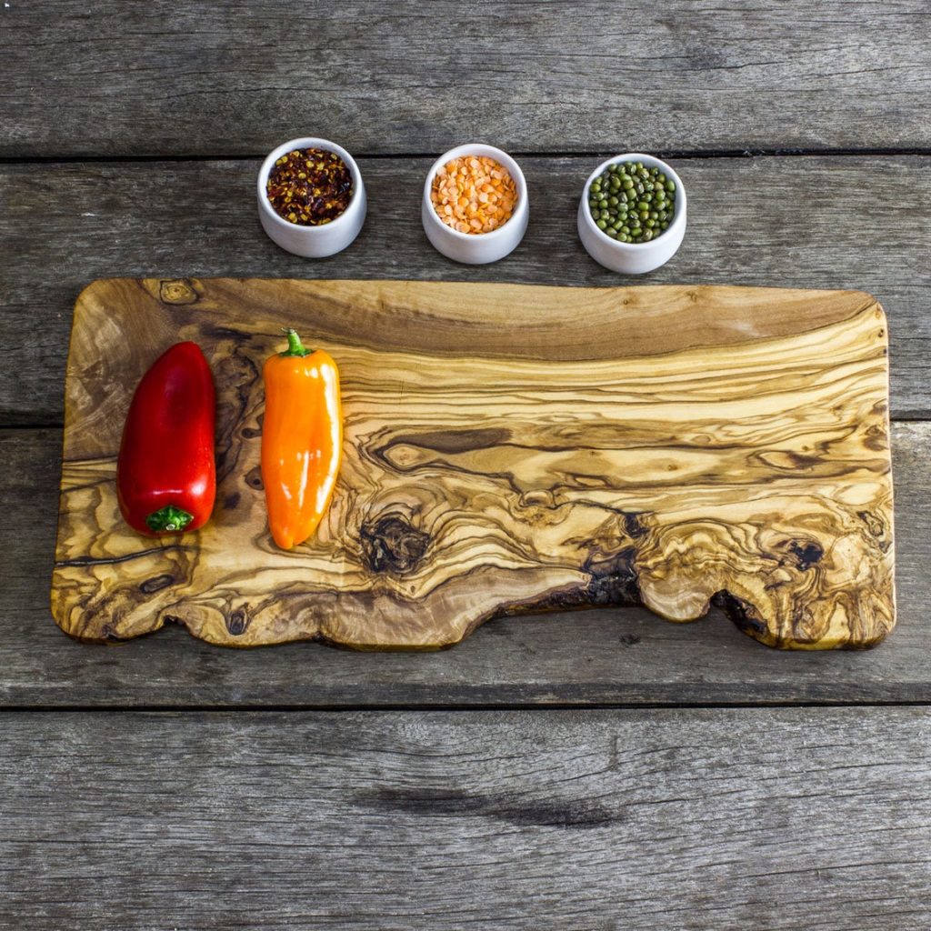 natural shaped olive wood cutting board with snacks