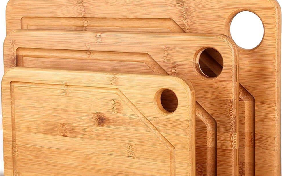 package of 3 bamboo cutting boards with holes in them