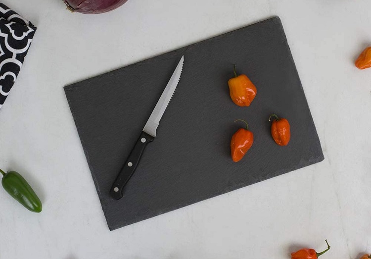 peppers and knife on slate cutting board