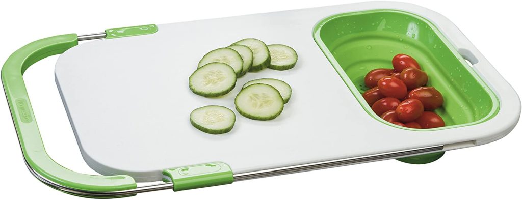 plastic green and white adjustble over sink cutting board holding produce