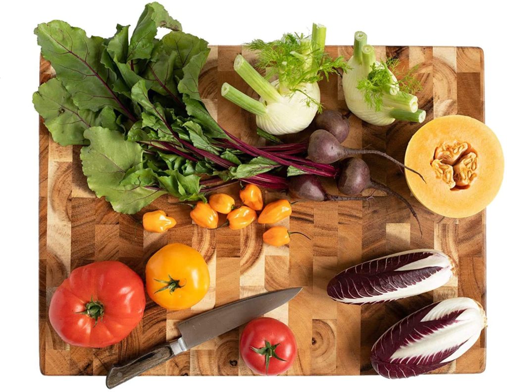 raw vegetables on acacia butchers block cutting board